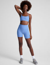 blue high-waisted 5" inseam biker shorts with side pockets.